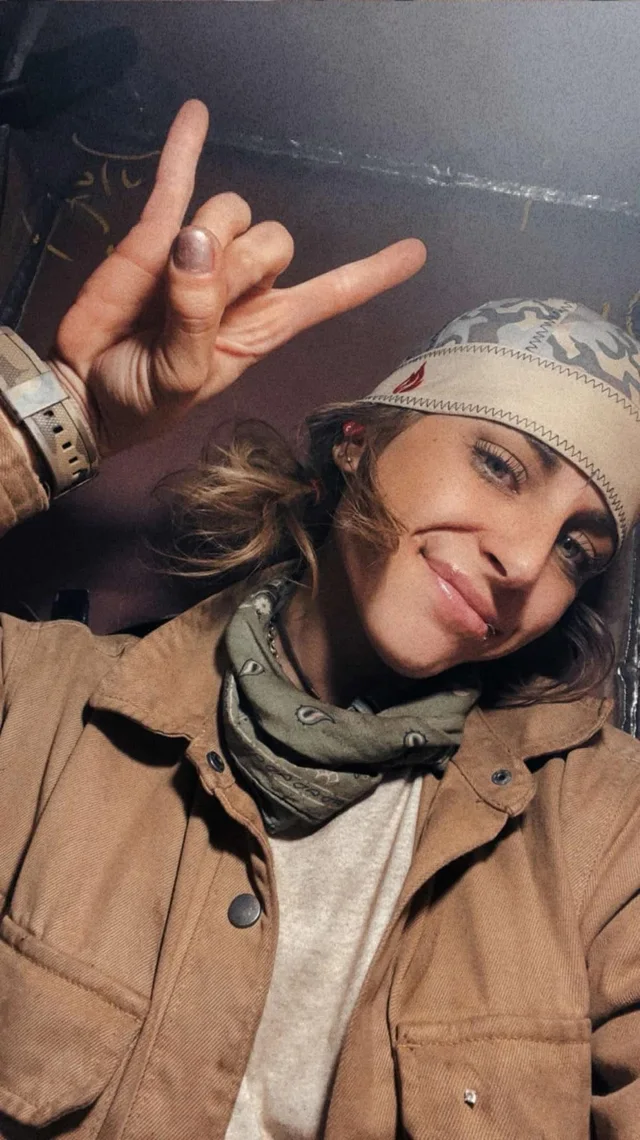 Tradeswoman wearing a Næxon camouflage welding cap and paisley bandana in an industrial work environment